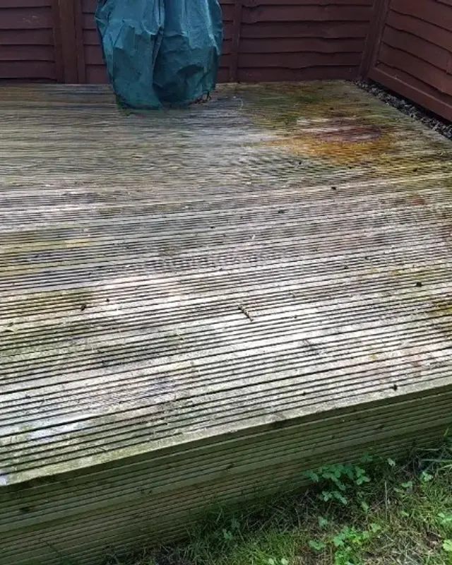 Grey weathered decking with green staining
