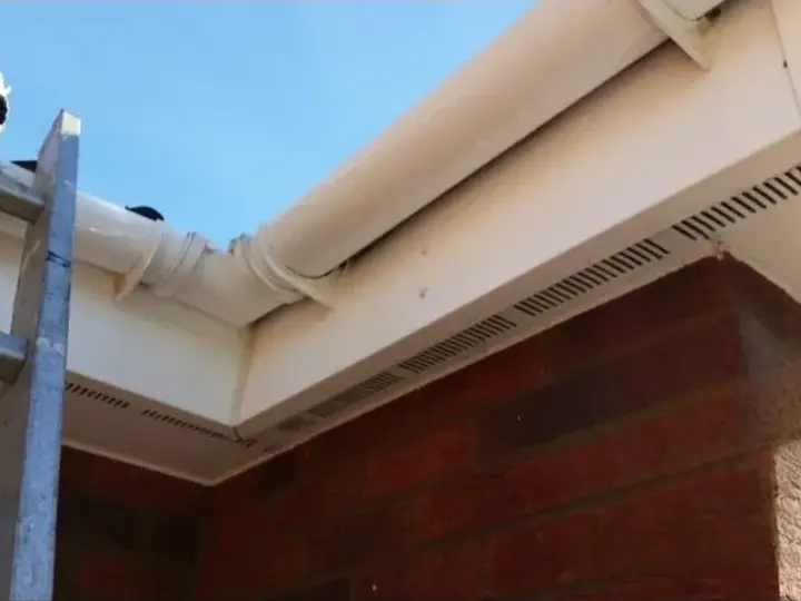 The same fascia and gutter bright white after cleaning