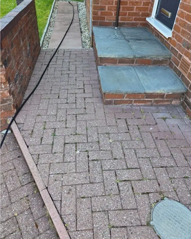Block paving and slate steps dull with dirt